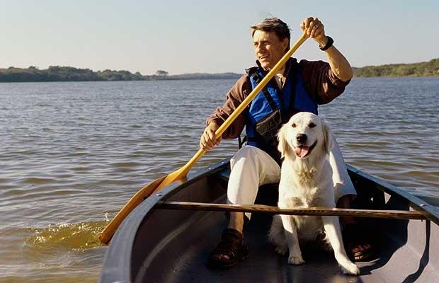 1356164126~A-white-Canoe-Dog-ridding-boat-with-its-owner.jpg